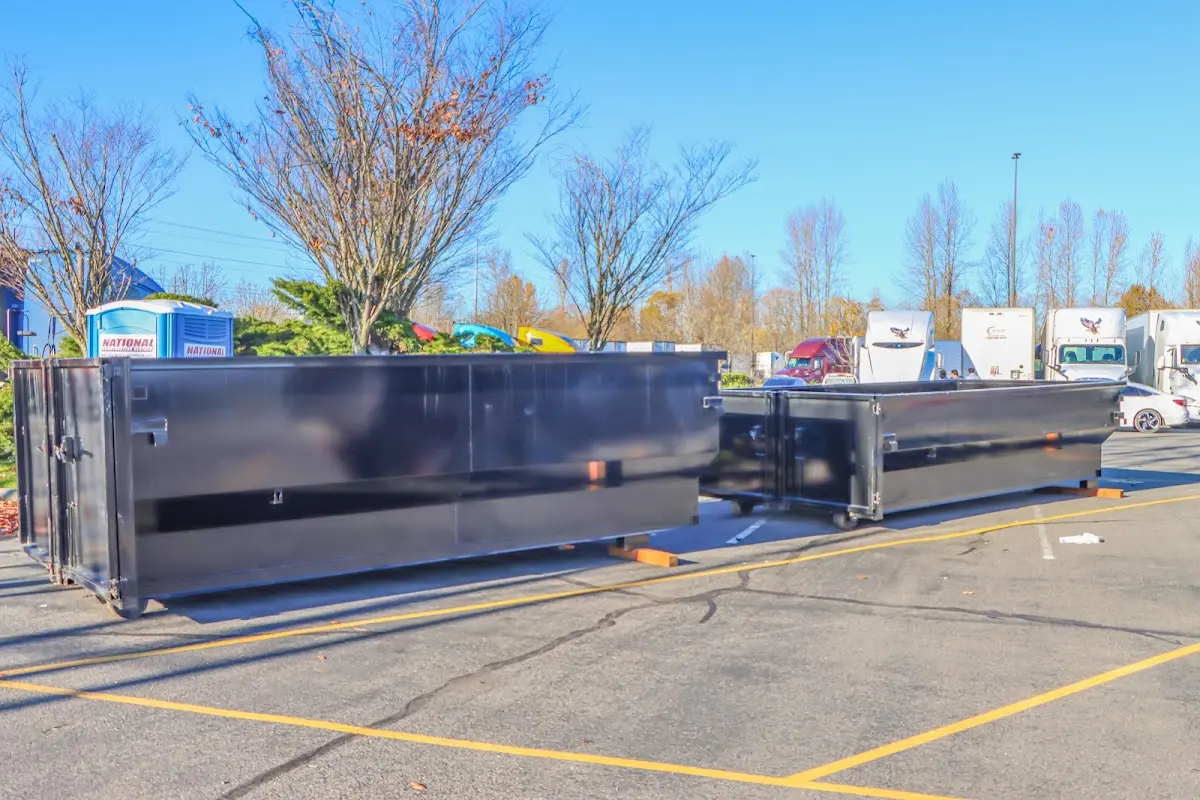 Professional dumpster rental service with roll-off container on residential driveway in Hazlet